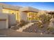 The home's entrance features a desert landscape, a lit staircase, and elegant architecture at 28754 N 107Th St, Scottsdale, AZ 85262