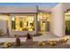 Contemporary home featuring desert landscaping, a modern entrance with oversized windows, and unique architecture at 28754 N 107Th St, Scottsdale, AZ 85262