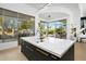 Spacious kitchen island with quartz countertop provides ample prep space and bar stool seating at 28754 N 107Th St, Scottsdale, AZ 85262