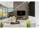 Comfortable living room with a modern fireplace, stylish decor, and sunlit window views at 28754 N 107Th St, Scottsdale, AZ 85262