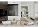 Stylish living room featuring modern decor, a sleek media wall, and an inviting entrance with lush greenery at 28754 N 107Th St, Scottsdale, AZ 85262