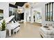 Spacious living room featuring a piano, wine storage, and modern decor at 28754 N 107Th St, Scottsdale, AZ 85262