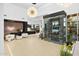 Bright living room with a glass-enclosed wine cellar, contemporary decor, and a view to the kitchen at 28754 N 107Th St, Scottsdale, AZ 85262
