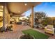 Relax on the covered brick patio with desert landscaping and views of the pool and outdoor living space at 28754 N 107Th St, Scottsdale, AZ 85262