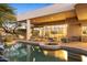 An inviting pool and spa are surrounded by elegant patio furniture and desert landscaping at this luxury home at 28754 N 107Th St, Scottsdale, AZ 85262