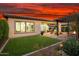 Beautiful home with a well-manicured backyard, featuring an outdoor pergola and mature desert landscaping at 29344 N 132Nd Ln, Peoria, AZ 85383
