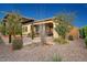 Beautiful backyard space with a covered patio, manicured landscaping, and a charming pergola at 29344 N 132Nd Ln, Peoria, AZ 85383