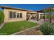 Spacious backyard featuring a covered patio, artificial turf, and desert-friendly landscaping at 29344 N 132Nd Ln, Peoria, AZ 85383