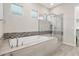 Bright bathroom showcasing a soaking tub with stylish mosaic tile accents and a separate glass-enclosed shower at 29344 N 132Nd Ln, Peoria, AZ 85383