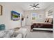 Cozy bedroom featuring neutral tones, a ceiling fan, and a wall-mounted TV for relaxed living at 29344 N 132Nd Ln, Peoria, AZ 85383