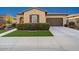 Charming home with manicured front lawn, desert landscaping, and attached two-car garage at 29344 N 132Nd Ln, Peoria, AZ 85383