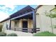 Exterior of a home with a covered patio featuring dark wood support columns and manicured landscaping at 29344 N 132Nd Ln, Peoria, AZ 85383