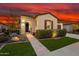 Charming single-story home with manicured lawn, desert landscaping, and beautiful stone walkway at 29344 N 132Nd Ln, Peoria, AZ 85383