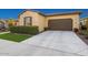 Charming home featuring a two-car garage, low-maintenance landscaping, and a concrete driveway at 29344 N 132Nd Ln, Peoria, AZ 85383