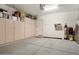 Well-organized garage with ample storage cabinets and a clean, epoxy-coated floor at 29344 N 132Nd Ln, Peoria, AZ 85383