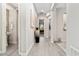 Bright hallway featuring elegant archways, wood-look floors, and stylish decorative accents at 29344 N 132Nd Ln, Peoria, AZ 85383