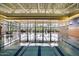 Indoor swimming pool with large windows, stone accent wall and exposed structural steel at 29344 N 132Nd Ln, Peoria, AZ 85383