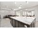 Bright, open-concept kitchen with granite counters, island seating, and seamless transition to living and dining areas at 29344 N 132Nd Ln, Peoria, AZ 85383