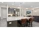 Open kitchen with granite counters, stainless appliances, large island with seating, and access to the living area at 29344 N 132Nd Ln, Peoria, AZ 85383