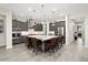 Gourmet kitchen with a large central island, stainless appliances, and barstool seating at 29344 N 132Nd Ln, Peoria, AZ 85383