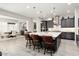 Open-concept kitchen with granite island, stainless steel appliances, and adjacent dining area at 29344 N 132Nd Ln, Peoria, AZ 85383