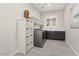 Functional laundry room equipped with storage solutions and a sink for added convenience at 29344 N 132Nd Ln, Peoria, AZ 85383