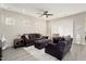 Comfortable living room with neutral paint, wood flooring and a ceiling fan at 29344 N 132Nd Ln, Peoria, AZ 85383