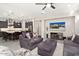 Open-concept living room flows into kitchen with updated flooring and a large television at 29344 N 132Nd Ln, Peoria, AZ 85383