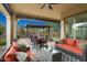 Inviting outdoor living area with comfortable seating and a dining set, perfect for entertaining or relaxing at 29344 N 132Nd Ln, Peoria, AZ 85383
