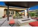 Inviting outdoor patio with a fire pit and dining space, perfect for entertaining at 29344 N 132Nd Ln, Peoria, AZ 85383