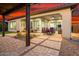 Spacious patio featuring a dining area and outdoor lounge seating, surrounded by lush landscaping and hardscape at 29344 N 132Nd Ln, Peoria, AZ 85383