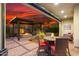 Inviting covered patio with a dining set, fire pit, and beautiful sunset views, perfect for outdoor entertaining at 29344 N 132Nd Ln, Peoria, AZ 85383