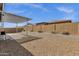 Large backyard area with gravel, a covered patio, and a block wall for privacy at 2962 E Birdsong Ave, San Tan Valley, AZ 85143