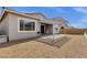 A view of the backyard with a patio cover, gravel and a clean, modern design at 2962 E Birdsong Ave, San Tan Valley, AZ 85143