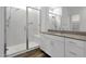 Bathroom featuring a walk-in shower with glass doors, a single-sink vanity, and modern finishes at 2962 E Birdsong Ave, San Tan Valley, AZ 85143