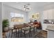 Inviting dining room with a large window and seating for eight at 2962 E Birdsong Ave, San Tan Valley, AZ 85143