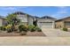 Charming single-story home with a two-car garage, stone accents, and lush desert landscaping at 2962 E Birdsong Ave, San Tan Valley, AZ 85143