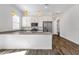Contemporary kitchen featuring white cabinetry, stainless steel appliances, and a spacious center island with quartz countertops at 2962 E Birdsong Ave, San Tan Valley, AZ 85143