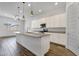 Modern kitchen with a large island, stainless steel appliances, stylish pendant lights, and ample cabinet space at 2962 E Birdsong Ave, San Tan Valley, AZ 85143