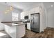 Bright kitchen featuring stainless steel appliances, white cabinets, an island, and modern pendant lighting at 2962 E Birdsong Ave, San Tan Valley, AZ 85143