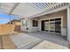 Covered patio features a pergola, brick-paved flooring, and views of the backyard space with sliding glass doors at 2962 E Birdsong Ave, San Tan Valley, AZ 85143