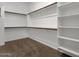 Spacious walk-in closet featuring built-in shelving and ample hanging space for organized storage solutions at 2962 E Birdsong Ave, San Tan Valley, AZ 85143