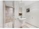 Modern bathroom featuring a pedestal sink, tile floors, and an accessible shower at 307 E Catalina Dr, Phoenix, AZ 85012