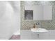 Modern bathroom featuring unique tilework, a wall-mounted sink, and a luxurious shower at 307 E Catalina Dr, Phoenix, AZ 85012