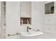 Modern bathroom vanity with stylish fixtures, built-in shelving, and storage cabinet at 307 E Catalina Dr, Phoenix, AZ 85012