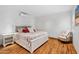 Cozy bedroom with hardwood floors, accent chair, and a queen sized bed at 307 E Catalina Dr, Phoenix, AZ 85012