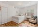 Neutral bedroom showcasing a platform bed, hardwood floors, and a cozy armchair at 307 E Catalina Dr, Phoenix, AZ 85012