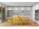 Bright dining room featuring a modern kitchen, hardwood floors and yellow chairs at 307 E Catalina Dr, Phoenix, AZ 85012