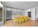 Bright dining room featuring a modern kitchen, hardwood floors and yellow chairs at 307 E Catalina Dr, Phoenix, AZ 85012