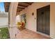 Covered entryway featuring a tiled porch, comfortable seating, and an inviting ambiance at 307 E Catalina Dr, Phoenix, AZ 85012